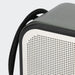 Swiss Peak 10W Bass Speaker - A grey and white portable speaker with a textured surface and a black strap attached.