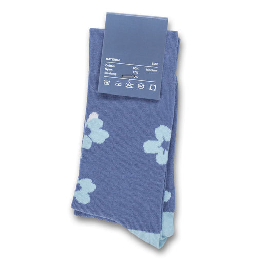 Pixel Knitted Knee-High Socks - A pair of blue knee-high socks featuring a floral pattern in lighter blue shades, with a tag showing size and material information.