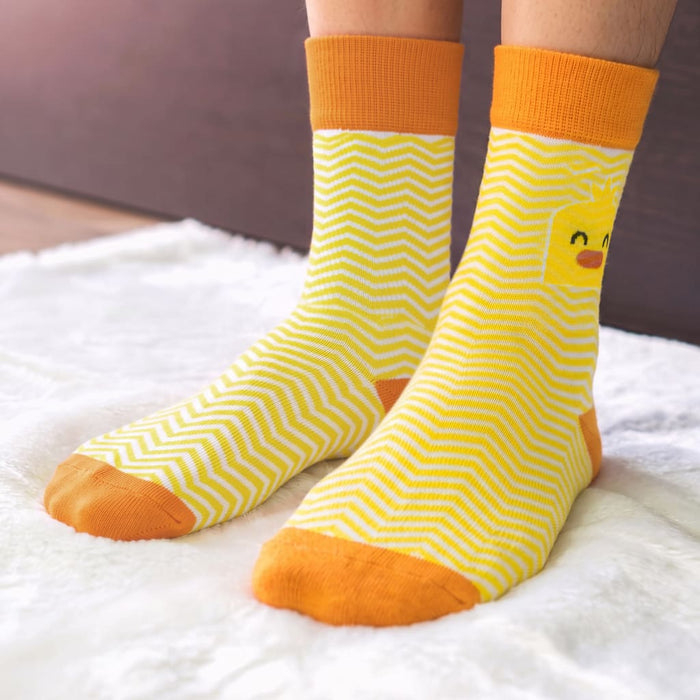 Pixel Knitted Business Socks - Set of 2 - A pair of yellow and orange knitted socks featuring a zigzag pattern and a playful design.