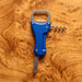 Multi-Tool Bottle Opener - A drink bottle opener in blue, featuring a knife, corkscrew, and a bottle opener, set on a wooden background.