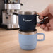 Stackable Stainless Steel Mug - A stackable stainless steel mug set in navy and light blue, featuring a handle and a logo, displayed on a wooden surface.