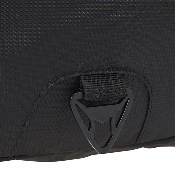 Fortress Laptop Backpack - A close-up of a black fabric section of a laptop backpack featuring a logo and a buckle attachment.