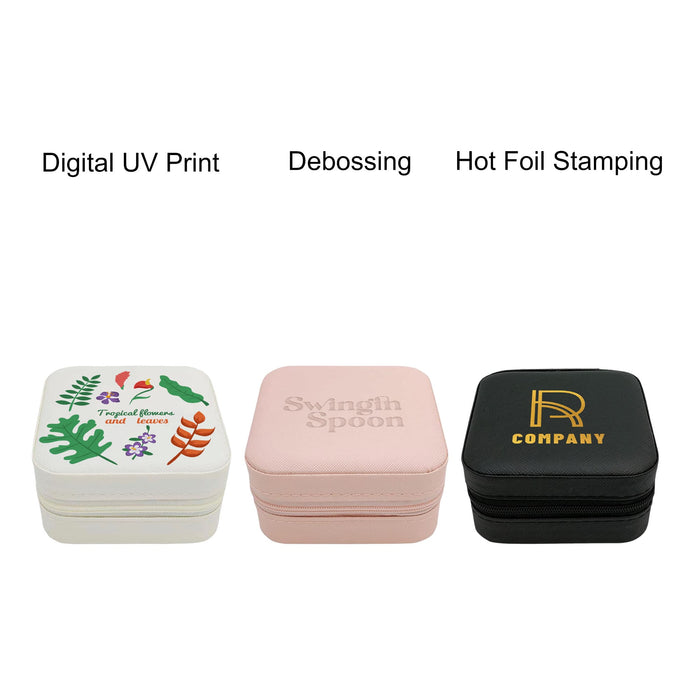 PU Leather Jewellery Box - A set of three PU leather jewellery boxes in white, pink, and black, featuring decorative designs and branding.