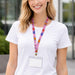 Retractable Lanyard - A retractable lanyard features a colourful, patterned strap with a clear ID holder, worn around a person’s neck.