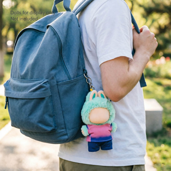 Plush Doll Jersey Outfit (15–17cm Doll) - A plush doll in a green and pink outfit attached to a blue backpack, featuring a keychain.