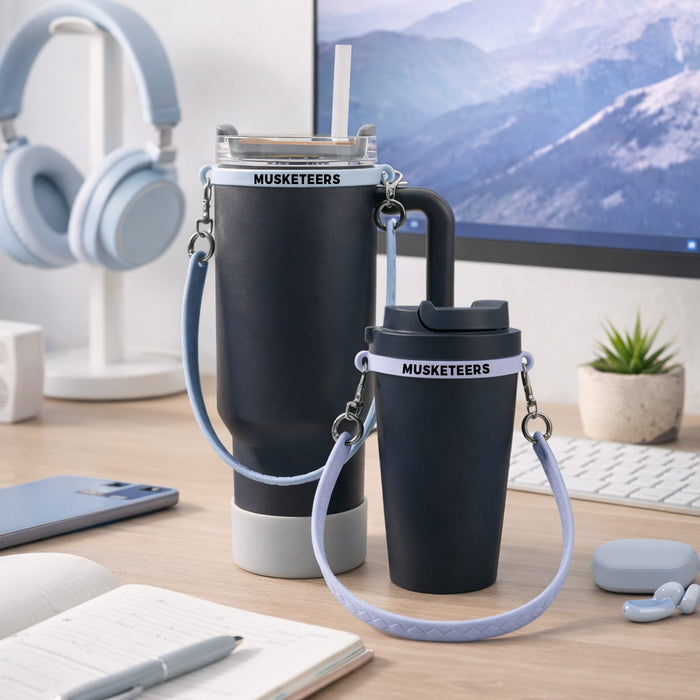 Silicone Cup Carry Strap - A drink bottle carrying two silicone cup carry straps in black and light blue, placed on a desk with headphones and stationery.