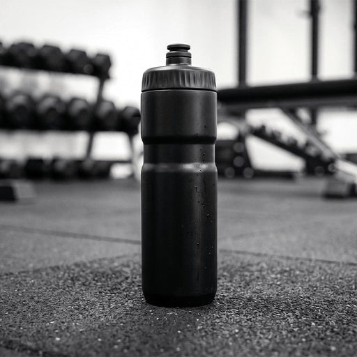 Sprint Sport Bottle 750ml - A drink bottle in black, standing upright on a gym floor with weights in the background.