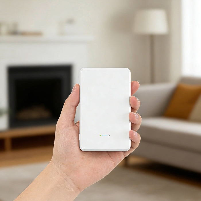 5000mAh Magnetic Wireless  Power Bank - A hand holding a white 5000mAh magnetic wireless power bank in a home setting with a fireplace and sofa in the background.