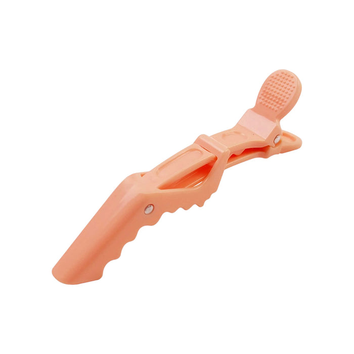 Anti-Slip Positioning Alligator Clip - An anti-slip alligator clip in a soft peach colour, featuring a textured grip and a branding logo.