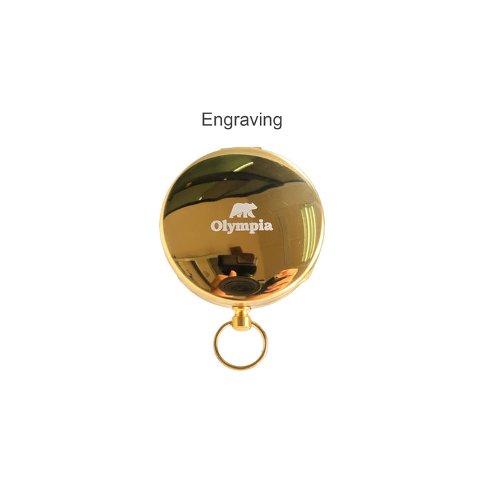 Luminous Compass - A gold pocket compass with a shiny finish, featuring a logo and a keyring attachment.