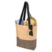 Paper Straw Tote Bag - 10L - A beige and black tote bag with black straps, containing a towel and a straw hat, and sunglasses resting on the bag.