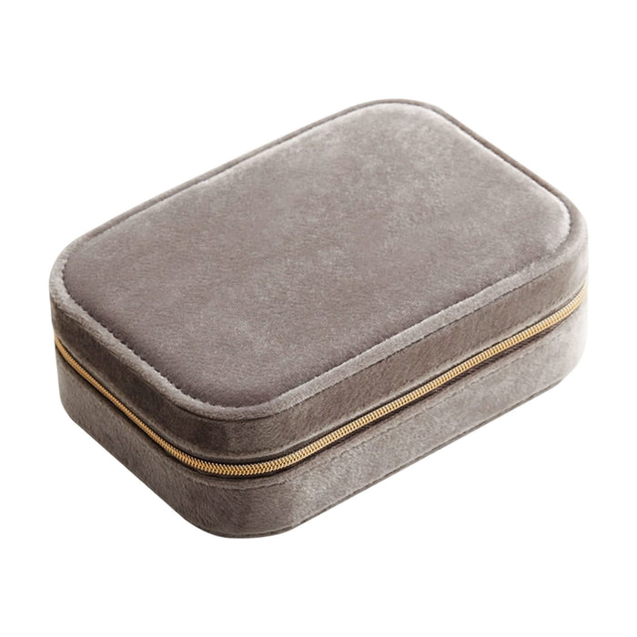 Velvet Jewellery Box with Compartment - A grey velvet jewellery box with a compartment and a zip closure. It features a subtle texture and a gold zipper.