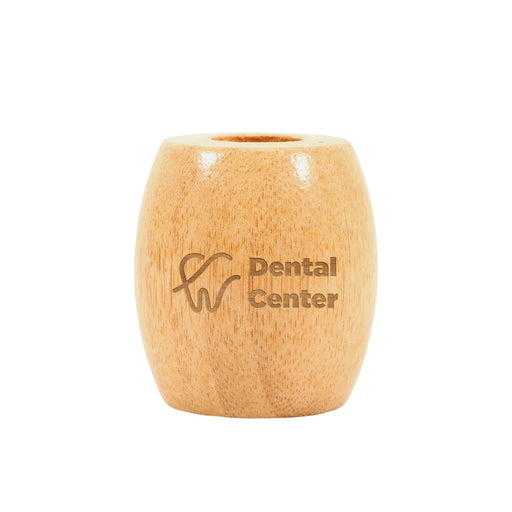 Bamboo Toothbrush Stand - A bamboo toothbrush stand in a light wood colour with a logo on the front.