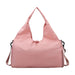 Duffle Bag With Yoga Mat Strap - A pink duffle bag featuring a yoga mat strap and a shoulder sling. It has a simple, modern design.