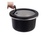 Oasis Microwave Safe Round S/S Container 680ml - A round, black stainless steel container with a clear lid and a handle. Features a sleek design and reflects modern styling.