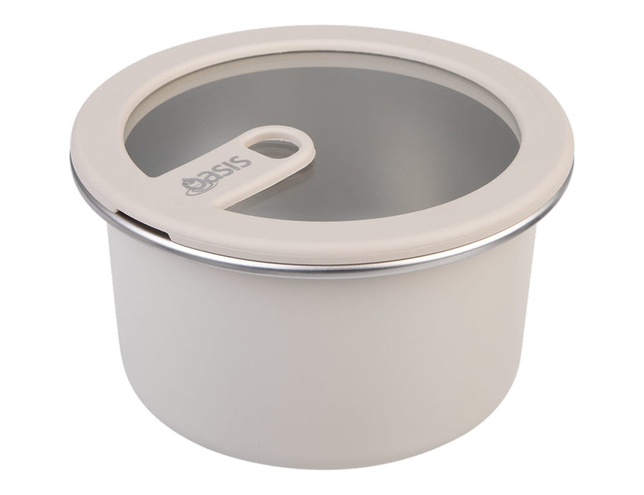 Oasis Microwave Safe Round S/S Container 680ml - A round, microwave-safe stainless steel container in cream with a clear lid and a handle, featuring a logo.