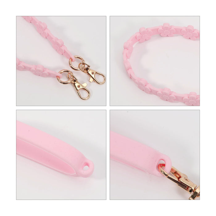 Silicone Flower Tumbler Strap - A drink bottle strap featuring a pink silicone design with flower details and gold clasps for attachment.