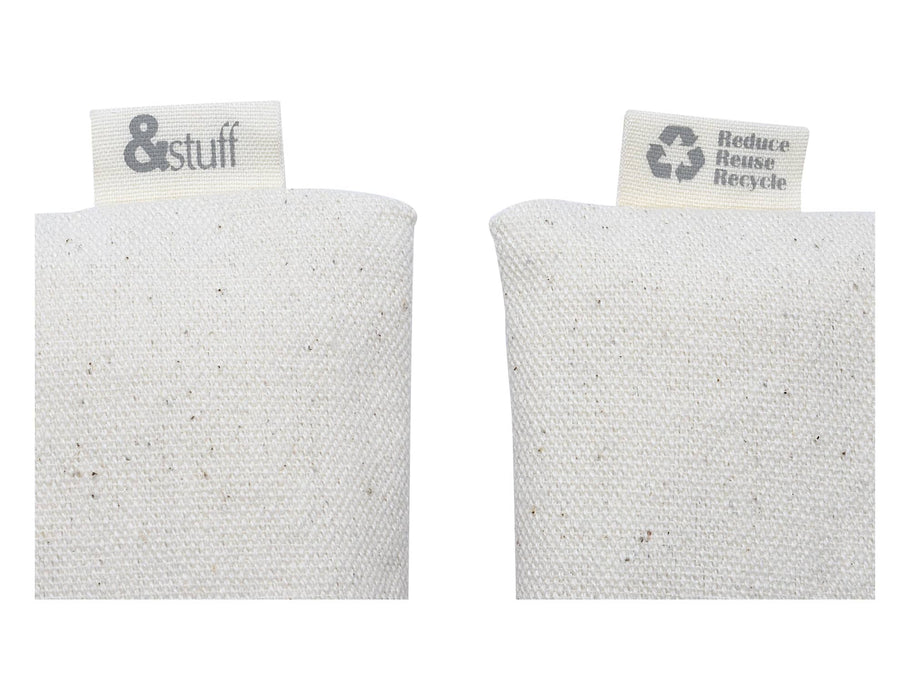 Calico Travel Set - A cream-coloured pouch made of textured material, featuring tags with logos on either side.