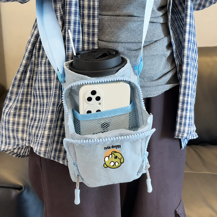 Water Bottle Holder with Strap - A drink bottle holder in light blue with a strap, featuring a pocket for a phone and a logo design.