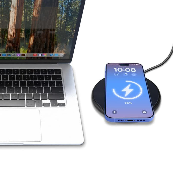 Casper Pro 15 Watt Eco Wireless Charger - A black wireless charger with a smartphone displaying a charging indicator, beside a laptop with a natural backdrop.