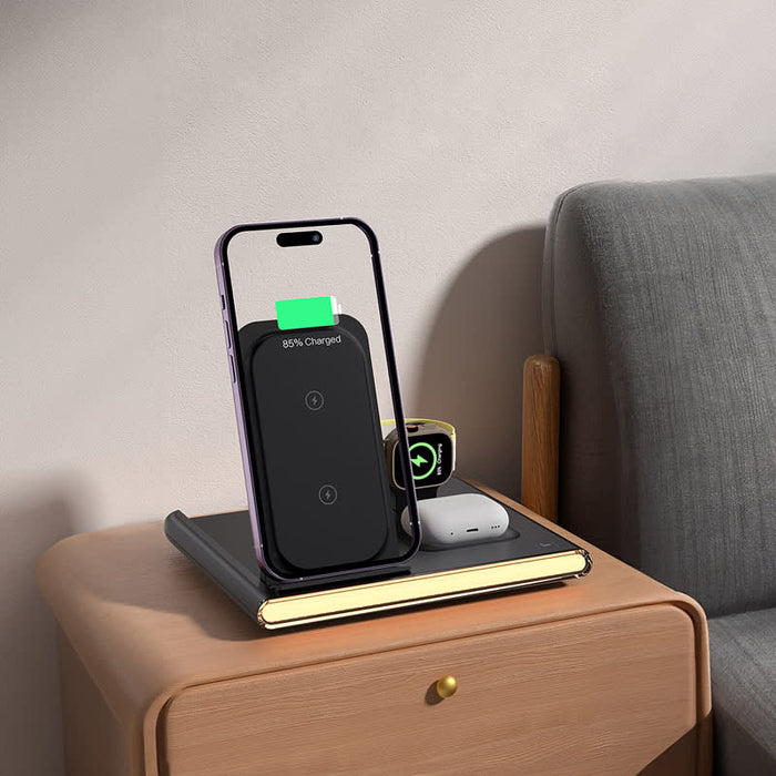 Haines 15W 3n1 Magnetic Wireless Charger & USB Adaptor - A magnetic wireless charger in black, positioned next to a phone on a wooden bedside table, with a small notebook and earbuds.