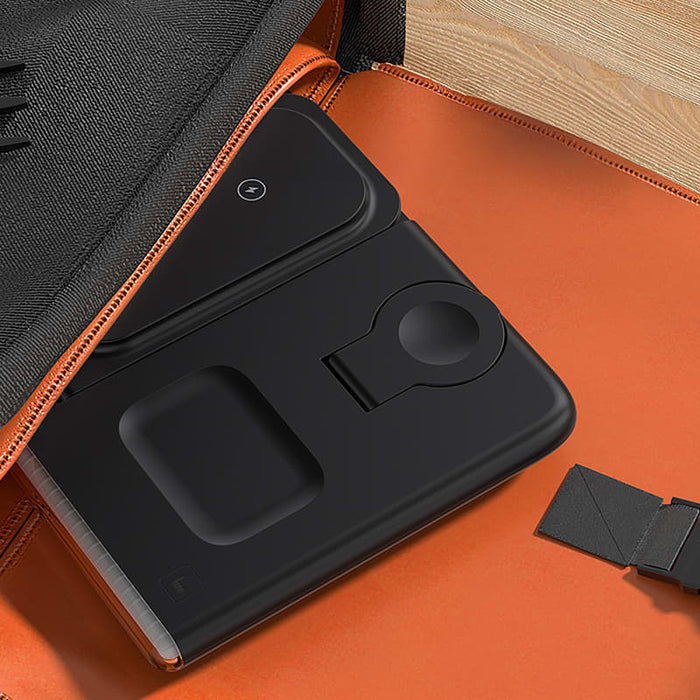 Haines 15W 3n1 Magnetic Wireless Charger & USB Adaptor - A black magnetic wireless charger and USB adaptor resting in an orange bag, showcasing its sleek design.
