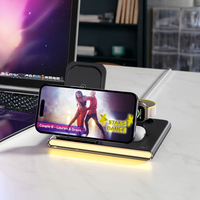 Haines 15W 3n1 Magnetic Wireless Charger & USB Adaptor - A wireless charger in black with a smartphone, earbuds, and a USB adaptor, set on a desk beside a laptop.