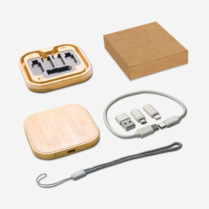 Coburg Pro Eco Cable Kit with 15W Wireless Charger - A bamboo wireless charger and a cable kit in a kraft box, featuring grey and silver connectors and a grey strap.