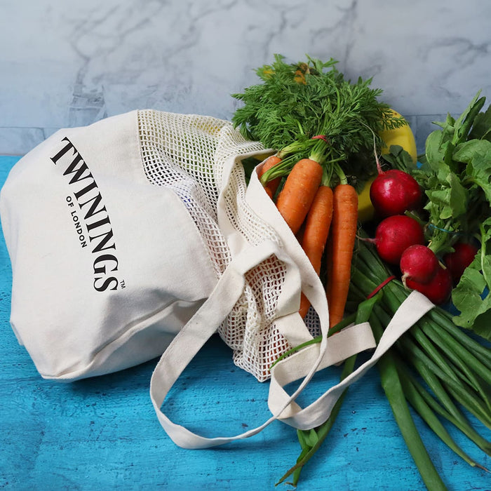 Maglia Cotton Shopping Tote - A cotton shopping tote in cream with a mesh top, filled with carrots, radishes, and fresh herbs.