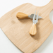Artis Cheeseboard & Knife Set - A bamboo cheese board with two stainless steel knives featuring light wooden handles.