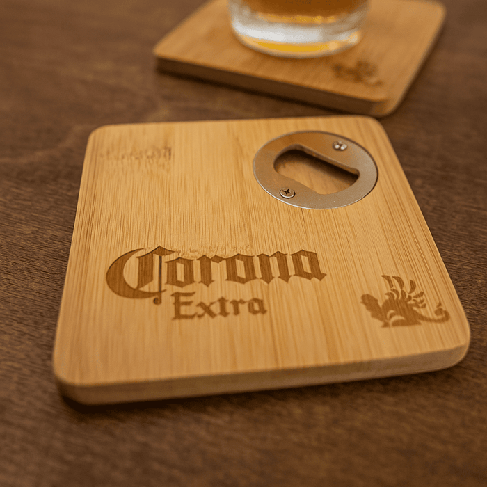 Square Bamboo Coaster - A square bamboo coaster featuring a bottle opener and a logo, set on a wooden surface with a drink.