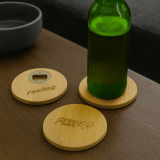 Round Bamboo Coaster - A green drink bottle rests on a round bamboo coaster, alongside two additional bamboo coasters with logos.
