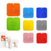 4-Section Dog Enrichment Lick Mat - A collection of four-section dog enrichment lick mats in orange, blue, yellow, grey, red, and pink. Each mat features various textured sections and has a logo.