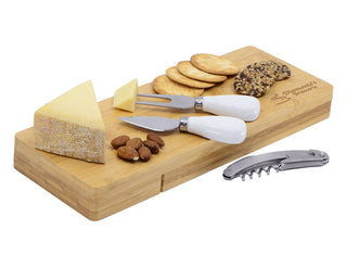 Picnic Cheese Set - A bamboo cheese board featuring cheese wedges, crackers, almonds, and three cheese knives with white handles.