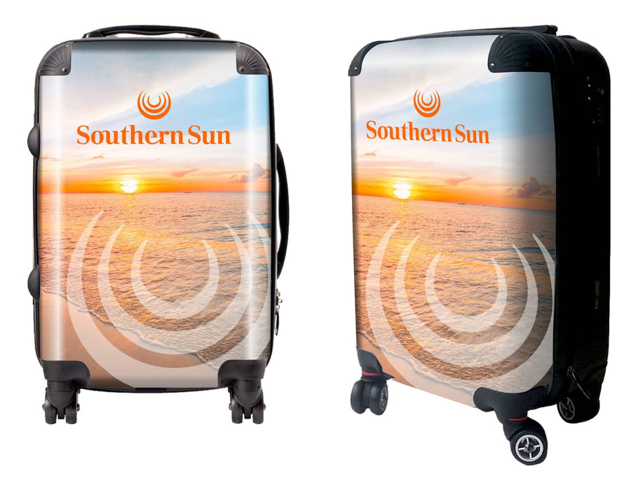 Traveller Carry-on Suitcase - A wheeled suitcase featuring a sunset beach design with a logo. The suitcase has a glossy finish and black wheels.