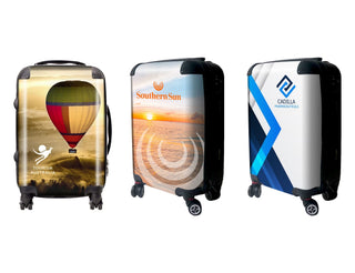 Traveller Carry-on Suitcase - Three wheeled carry-on suitcases featuring colourful designs, including a hot air balloon, sunset, and abstract patterns.