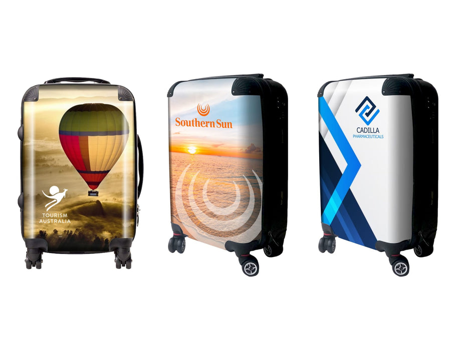 Traveller Carry-on Suitcase - Three wheeled carry-on suitcases featuring colourful designs, including a hot air balloon, sunset, and abstract patterns.