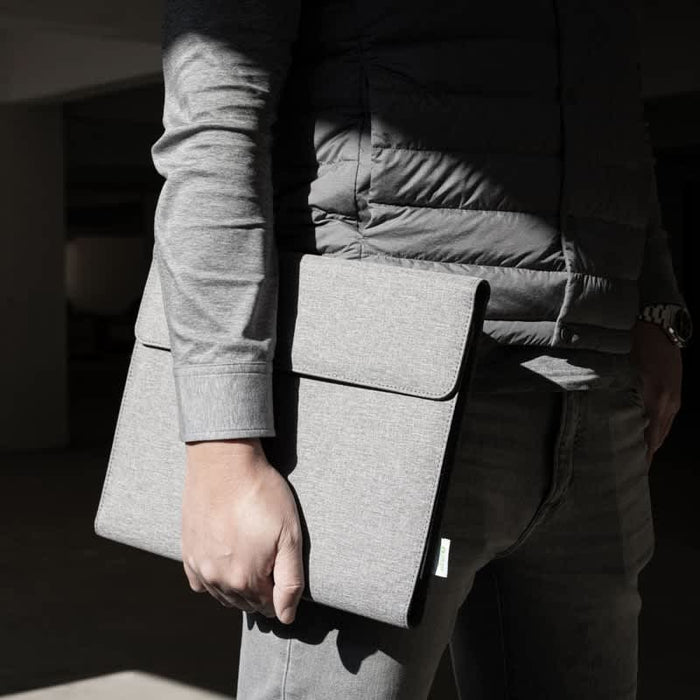 Noty Folio Eco (Business Folio) - A grey business folio held by a person in a grey shirt, showcasing a simple, sleek design.