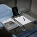 Noty Folio Eco (Business Folio) - A grey business folio displayed on a table, featuring a tablet stand, notepad, and pen.