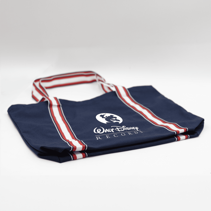 Century Canvas Tote Bag - A navy canvas tote bag with red and white stripes and a logo. It has two sturdy handles for carrying.