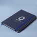 Space A5 Notebook - A navy A5 notebook with an elastic band closure and an Olympic-themed logo on the cover.