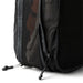Bellroy Lite Packing Cube 12L - A black packing cube with a mesh side and a zippered opening, showcasing its compact design.