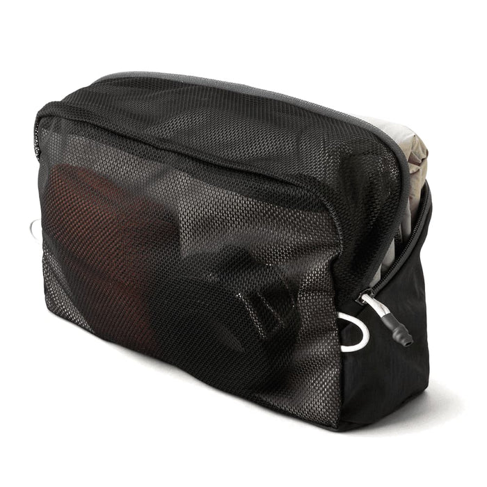 Bellroy Lite Packing Cube 6L - A black mesh packing cube containing various items, showcasing its organisational features and content visibility.