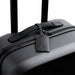 Bellroy Luggage Tag - A black suitcase featuring a sleek leather luggage tag with a braided attachment. It has a minimalist design and a logo.