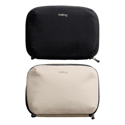 Bellroy Lite Tech Kit - A black and a beige tech kit with zippers, both featuring a logo on the front.