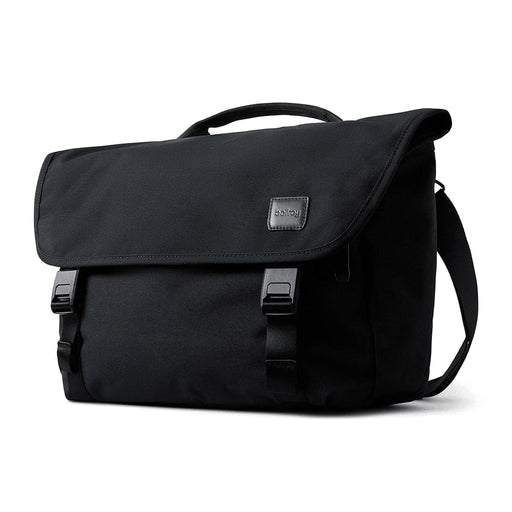 Bellroy Classic Messenger 13L - A black messenger bag featuring a flap closure, buckles, and a carrying handle, with a logo on the front.