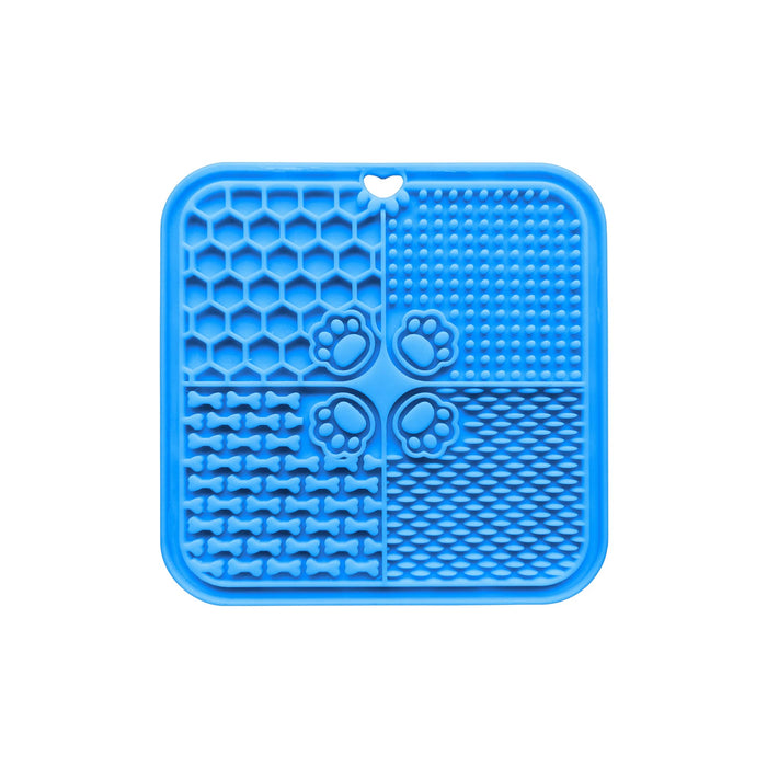 4-Section Dog Enrichment Lick Mat - A blue, silicone dog enrichment lick mat divided into four sections with various textured patterns and a paw print design.