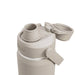 CamelBak - Thrive Chug VSS 0.6L - A drink bottle in a light beige colour with a flip-top lid and a built-in straw, featuring a logo.