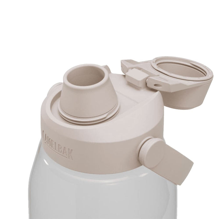 CamelBak - Thrive Chug 1.5L - A drink bottle with a beige lid, featuring a chug valve and a sturdy design. The bottle is clear and has a brand logo.