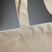 440gsm Kensington Recycled Cotton Tote Bag - A light beige recycled cotton tote bag featuring sturdy shoulder straps and a simple design, with a branding logo.